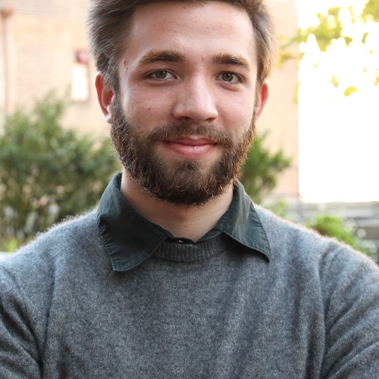 smiling male student in sweater