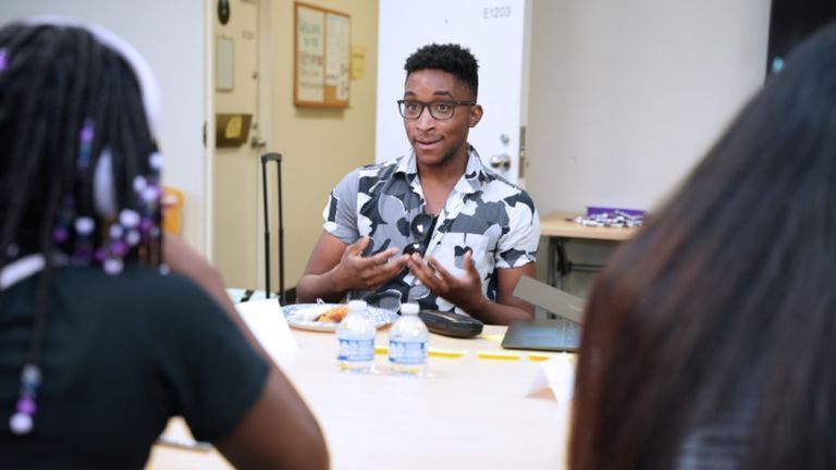 Teacher Matt Blake speaks about English composition with YEP students.