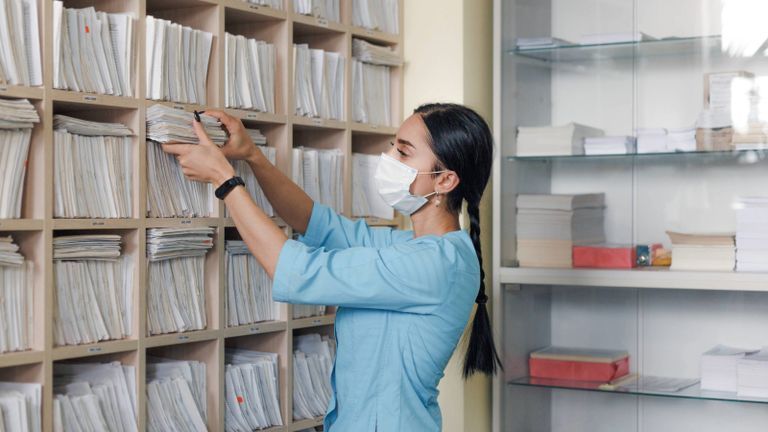 Medical worker retrieving files.