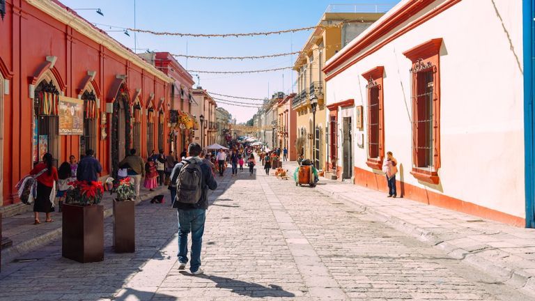 image of a student walkingn down a street in Mexico