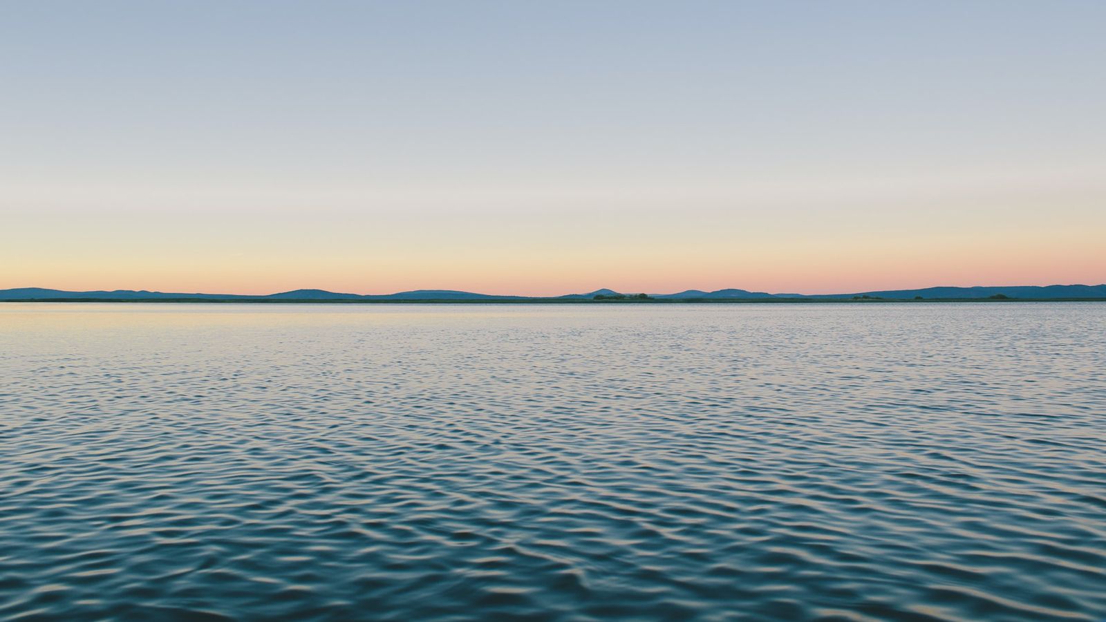 Photo of calm, limpid, blue water and rosy sky to illustrate Mastering Anxiety