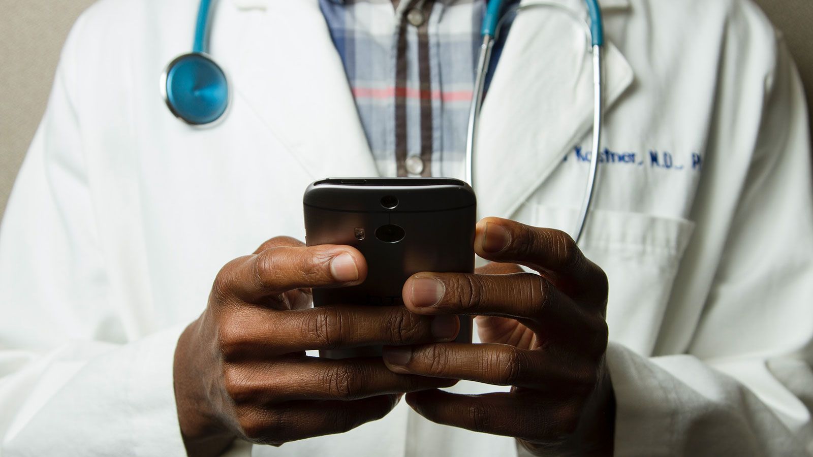 medical professional holding a cell phone
