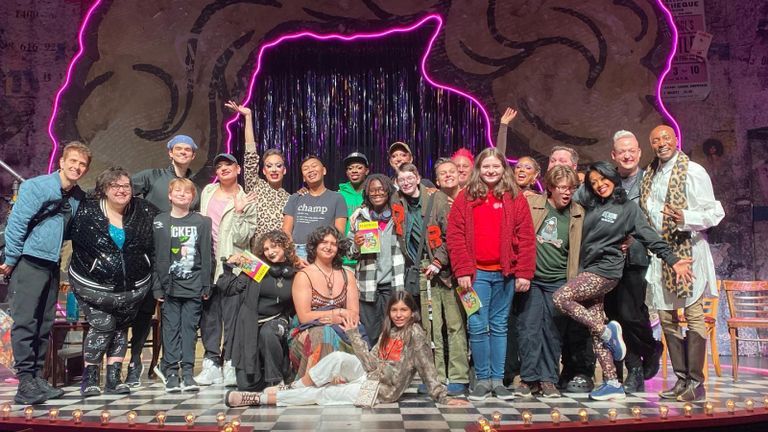 Theatre artist smile on stage at National Queer Theater.