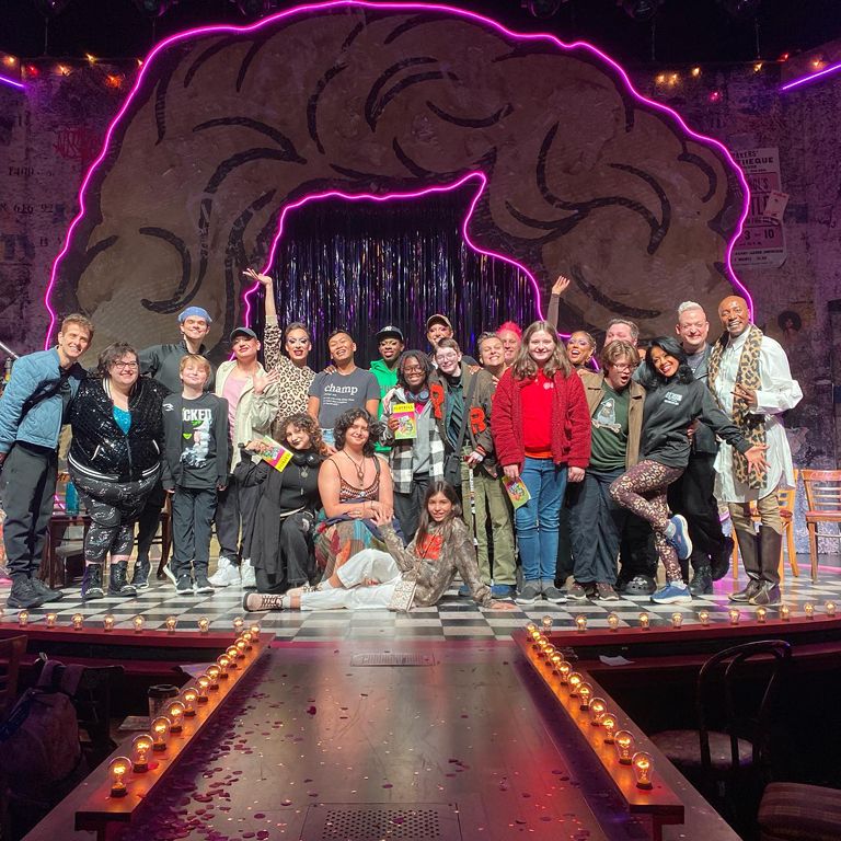 People smile on stage of the National Queer Theater.