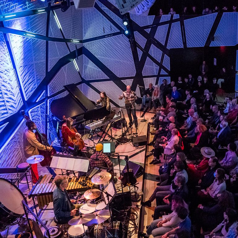 Musicians perform on stage while audience watches at National Sawdust.
