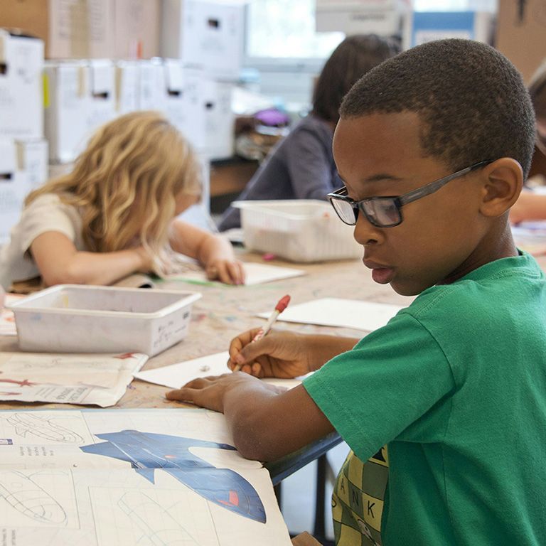 young students in classroom setting at table