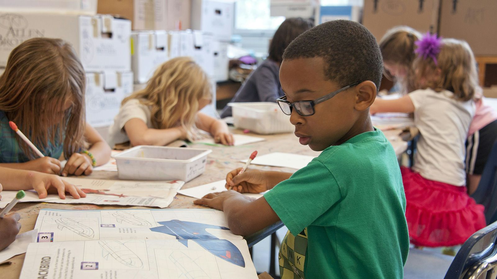group of young students working in a classroom setting