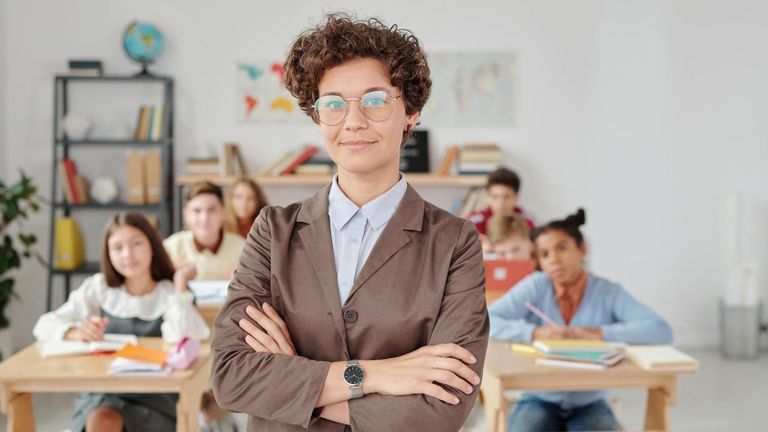 teacher in front of classroom with young students