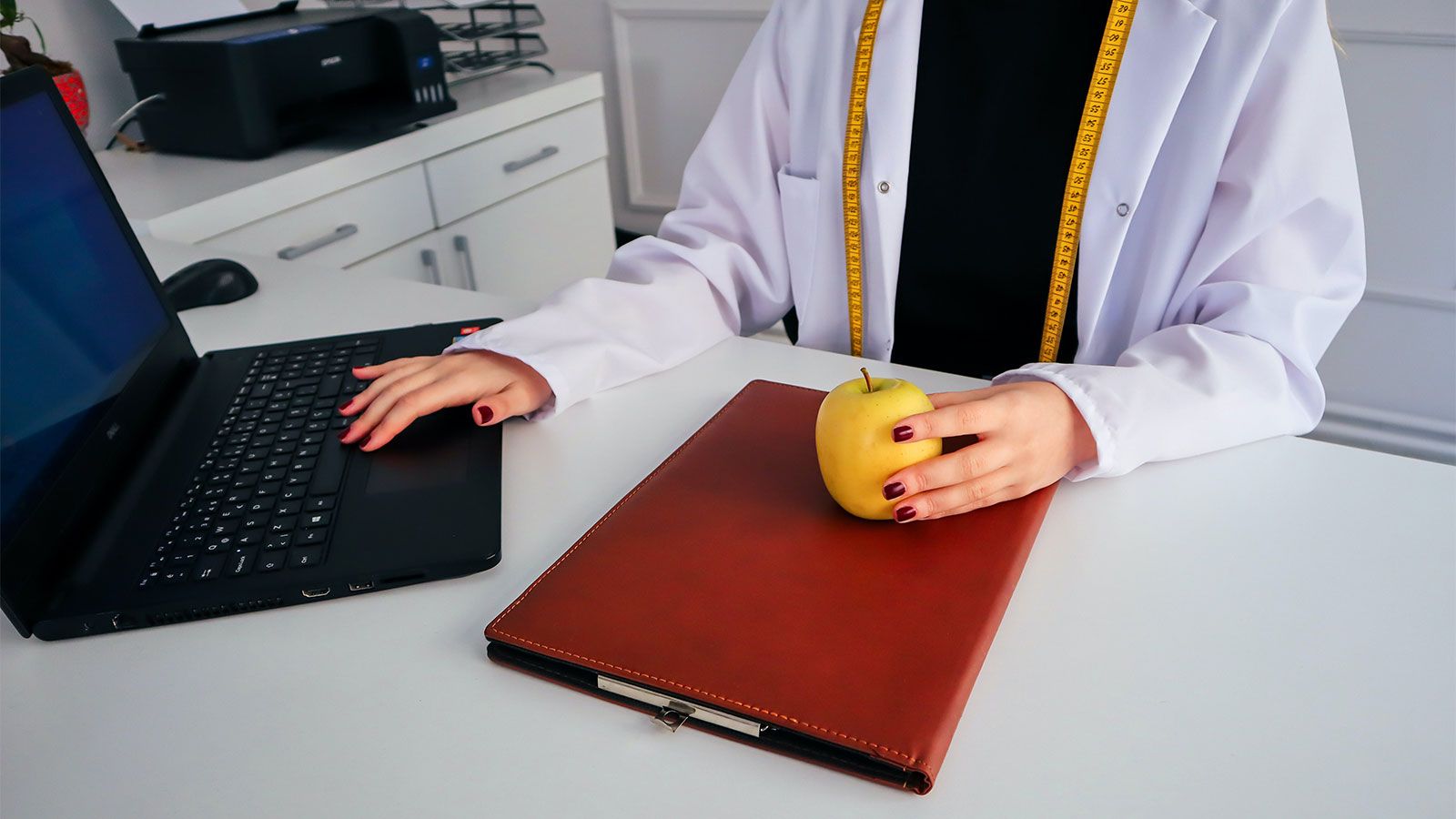 nutritionist at desk with laptop