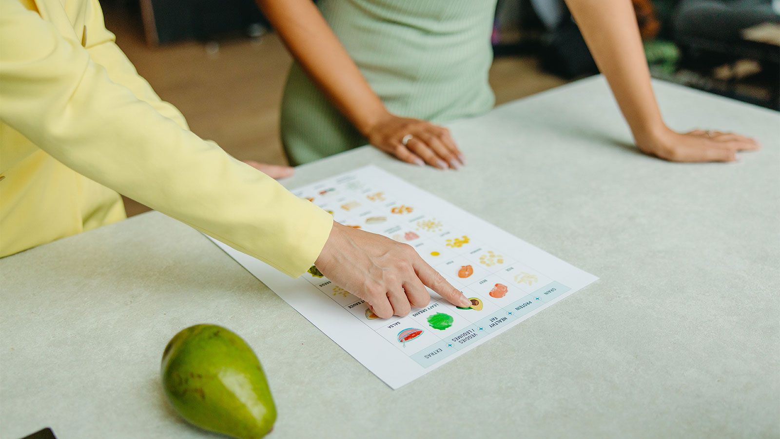 nutritionist showing patient food chart