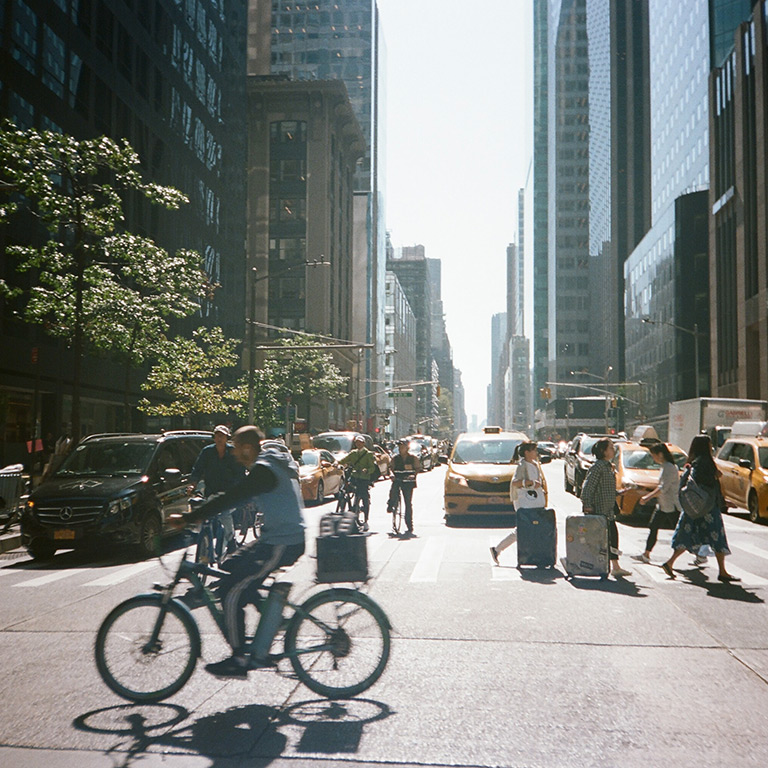 nyc street with cyclist and pedestrians