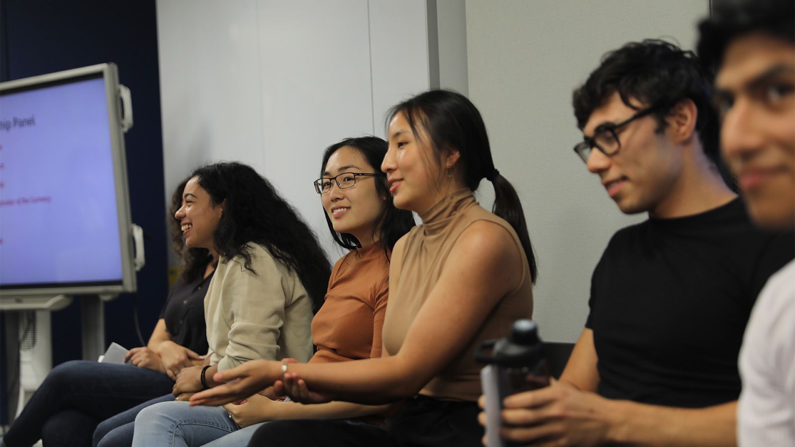 students on stage at open house for cooperman business