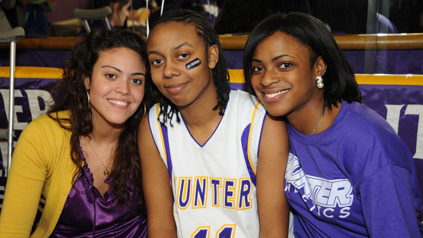 3 student athletes smiling