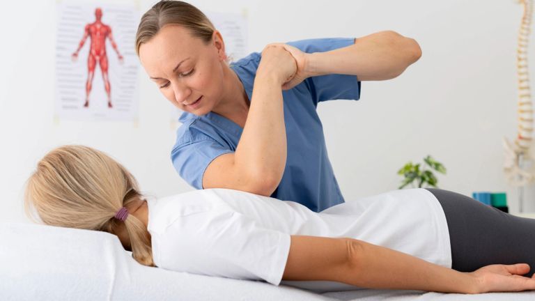 Osteopathic therapist performing hands-on treatment to patient  