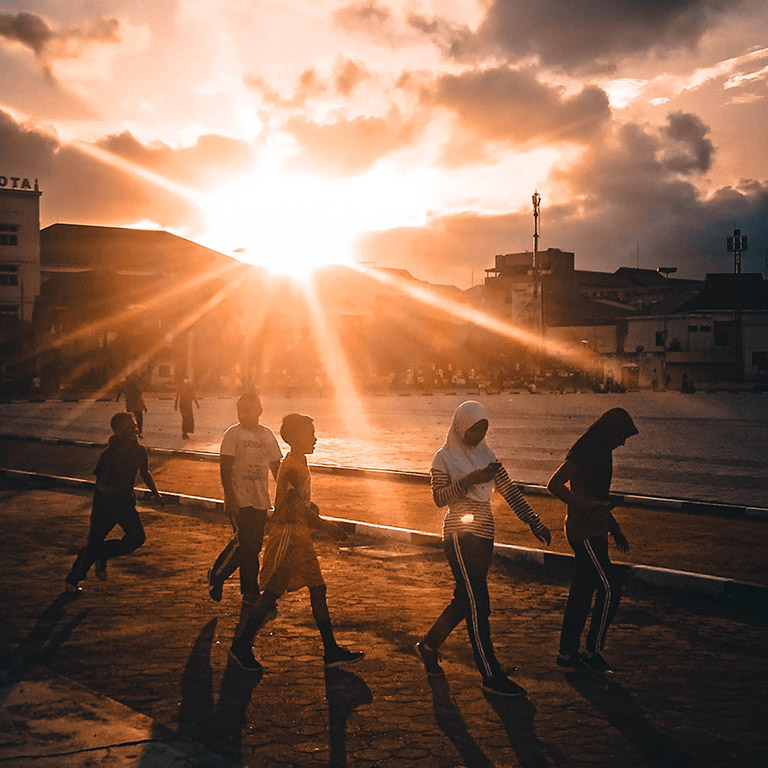 people walking at sunset in Maluku Indonesia