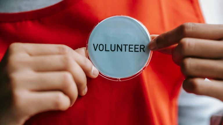 woman holding volunteer label