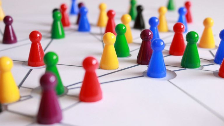 A diverse group of colorful individuals interconnected, representing networking opportunities