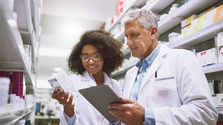 Two pharmacists looking at a sample