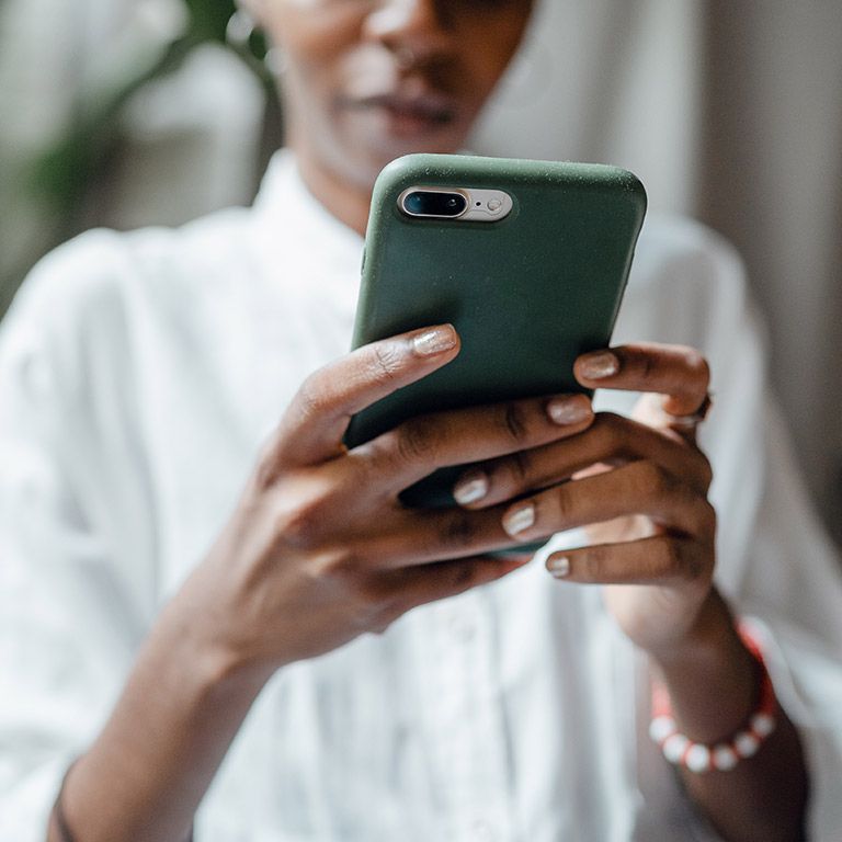 Black person with phone in hands