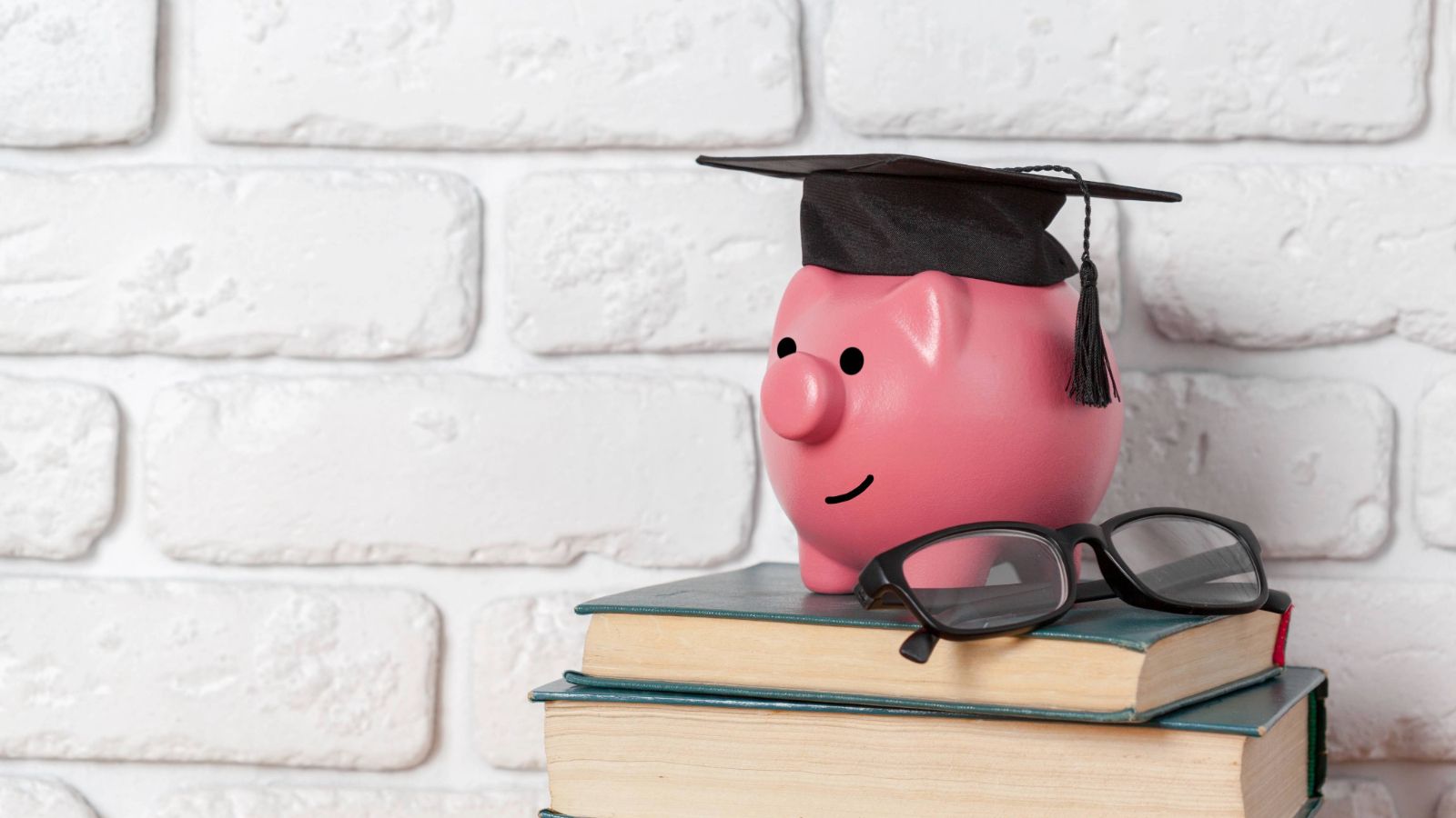 Piggy bank on top of a stack of books