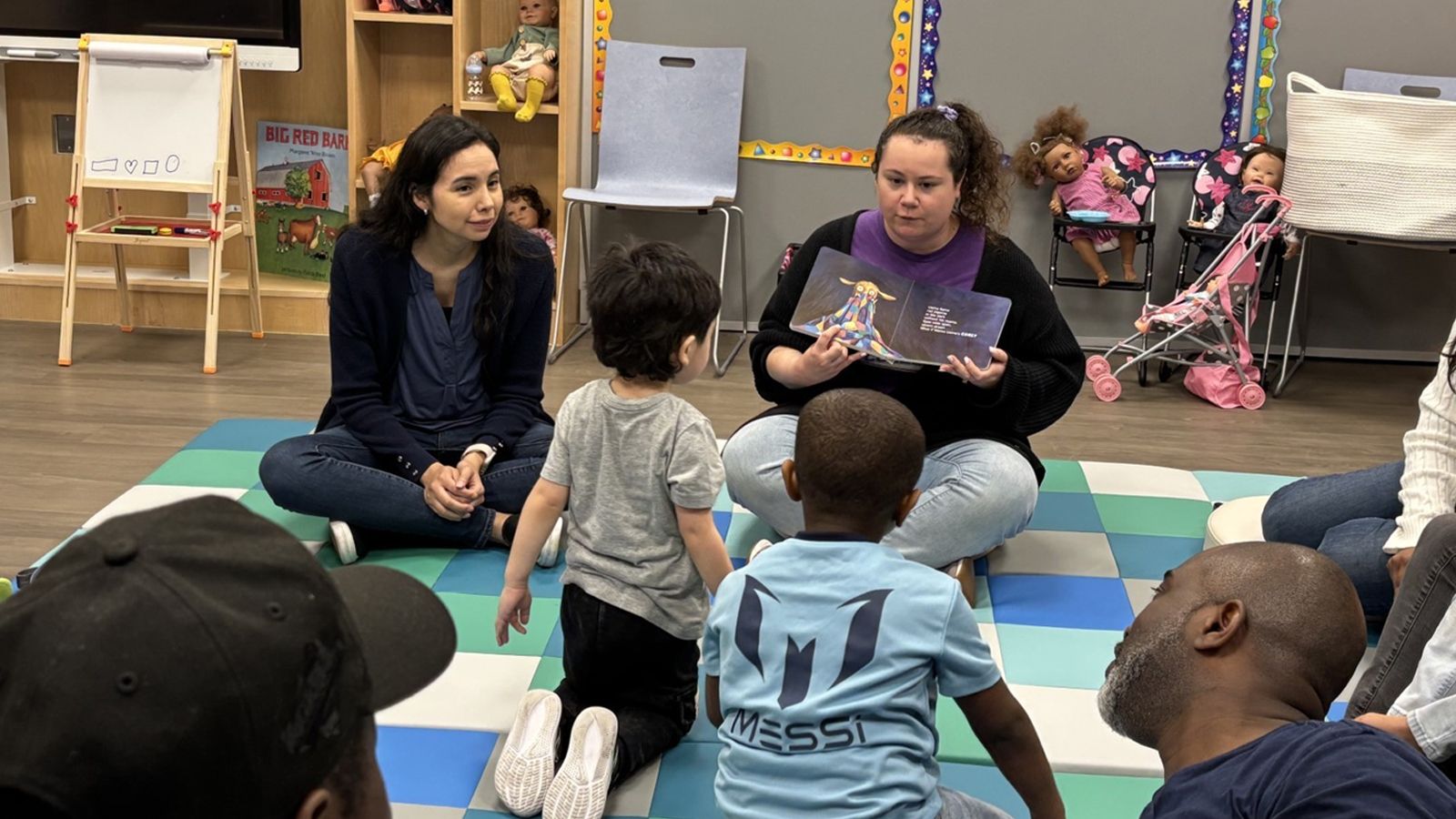Students read aloud to children in the playgroup
