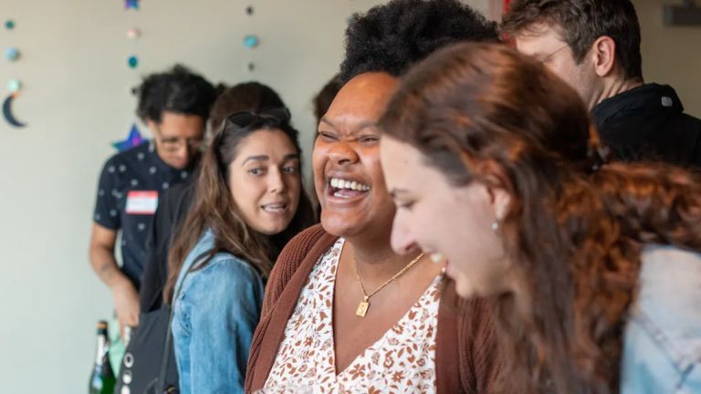 Students smiling and laughing at a Playwrights Horizons event.