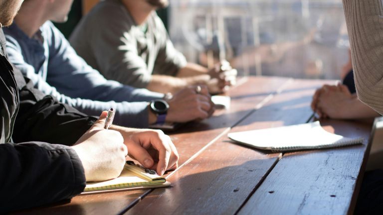 students taking notes at a desk