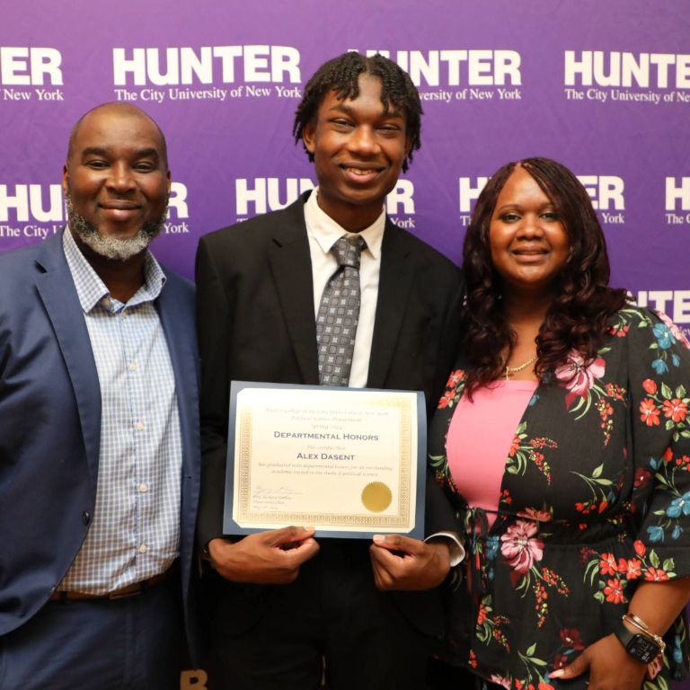 student holding up an award