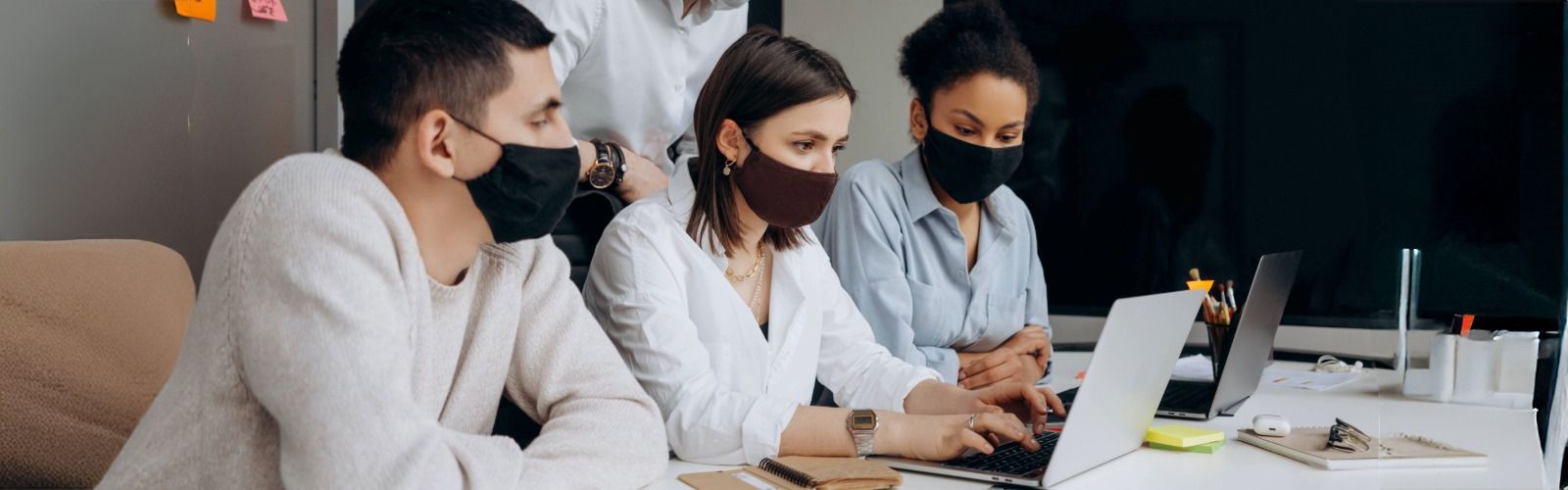 Group of students using laptop.