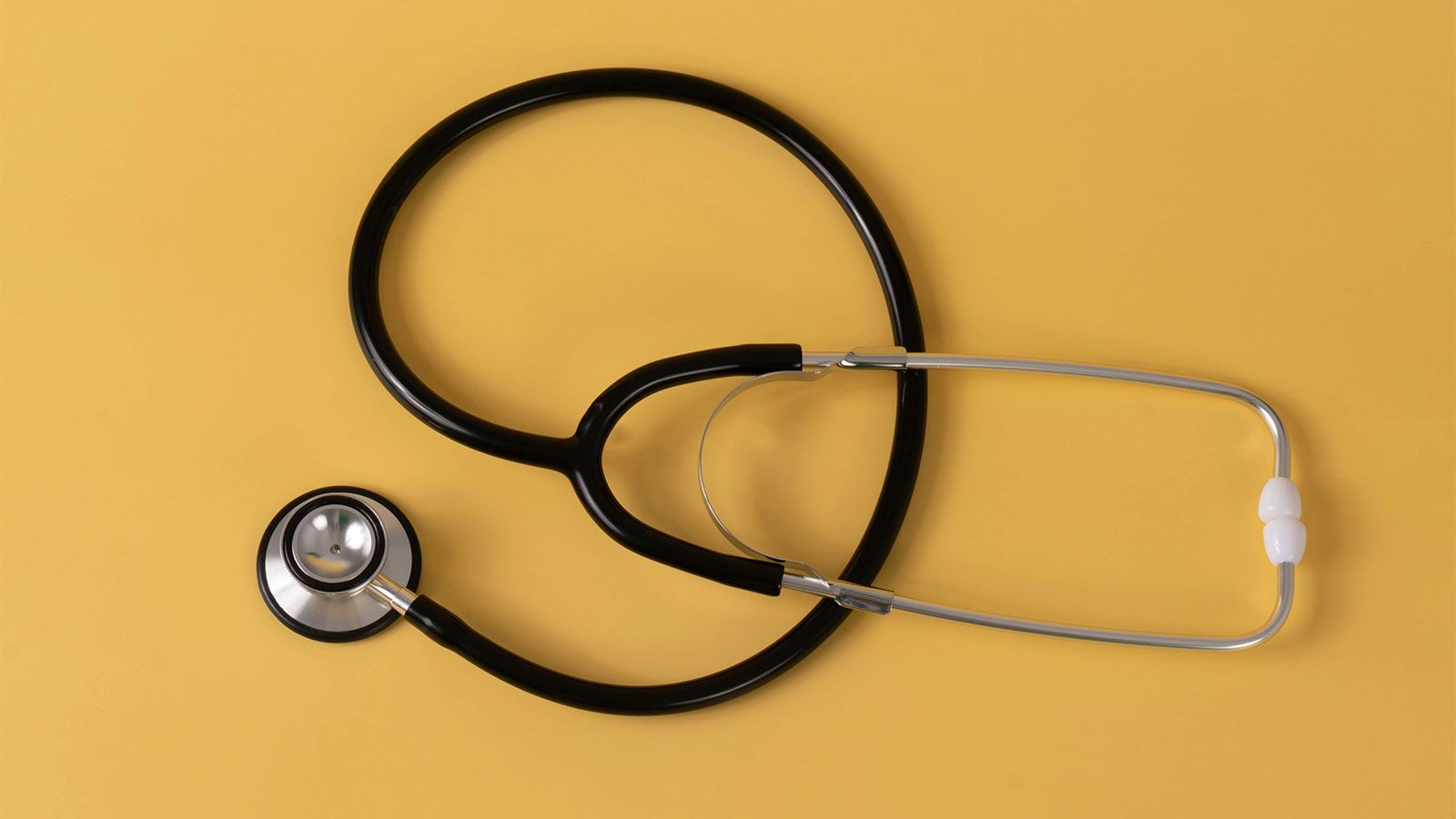 photo of stethoscope with a yellow background