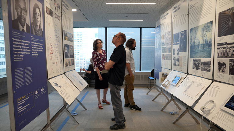 Patrons reading the States of Incarceration exhibit.