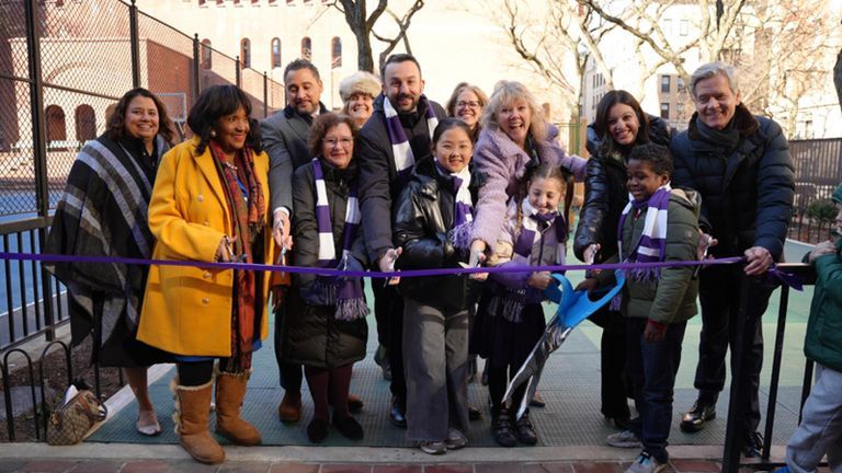 Students, Hunter officials, local officials, and guests cut the ribbon at the new Ron H. Brown Playground.