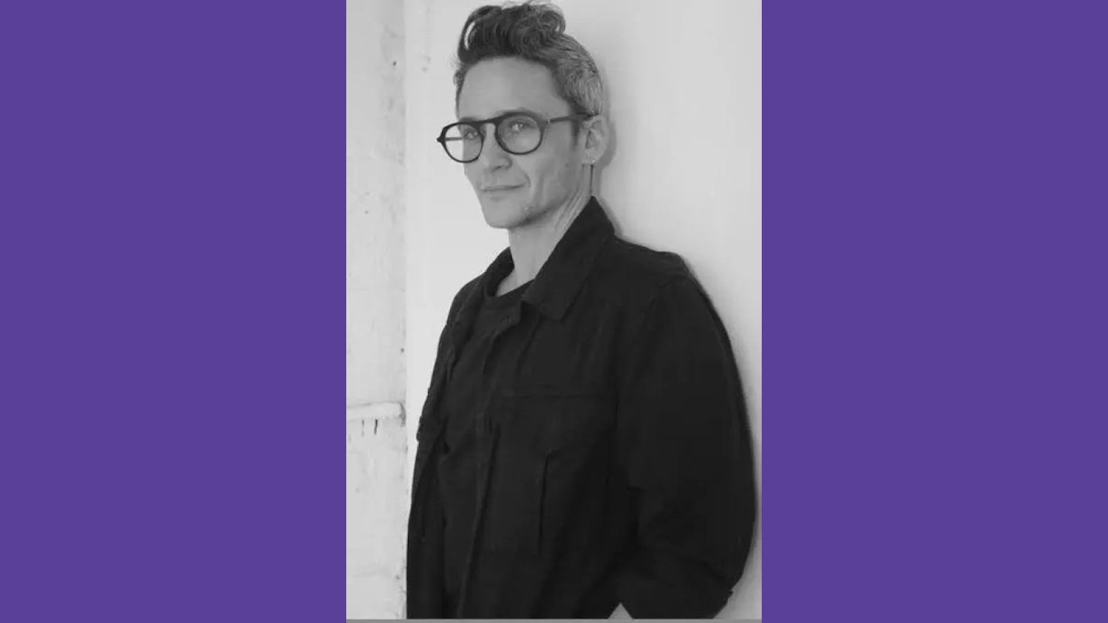 Black and white photo of Sam Feder in a blazer.