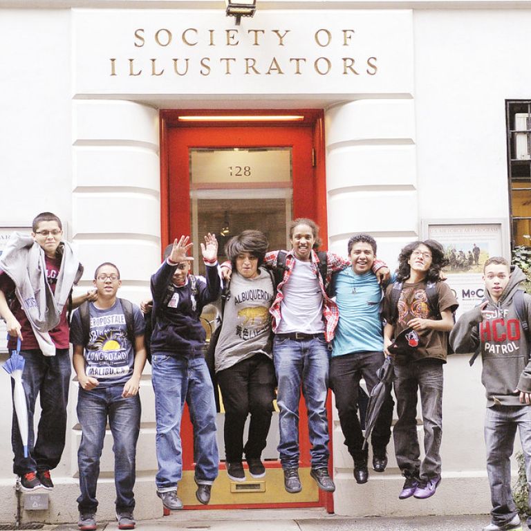 Students jumping for picture in front of Society of Illustrators