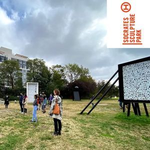People admire artwork in Socrates Sculpture Park.