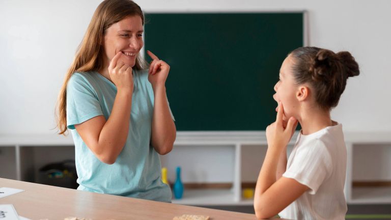 Speech-language pathology therapist providing speech guidance to child