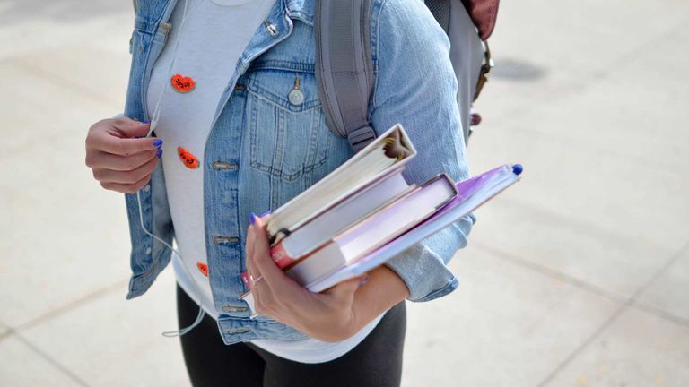 person holding books