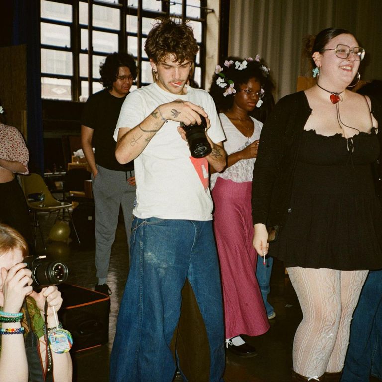 Students take photos at a photography event.