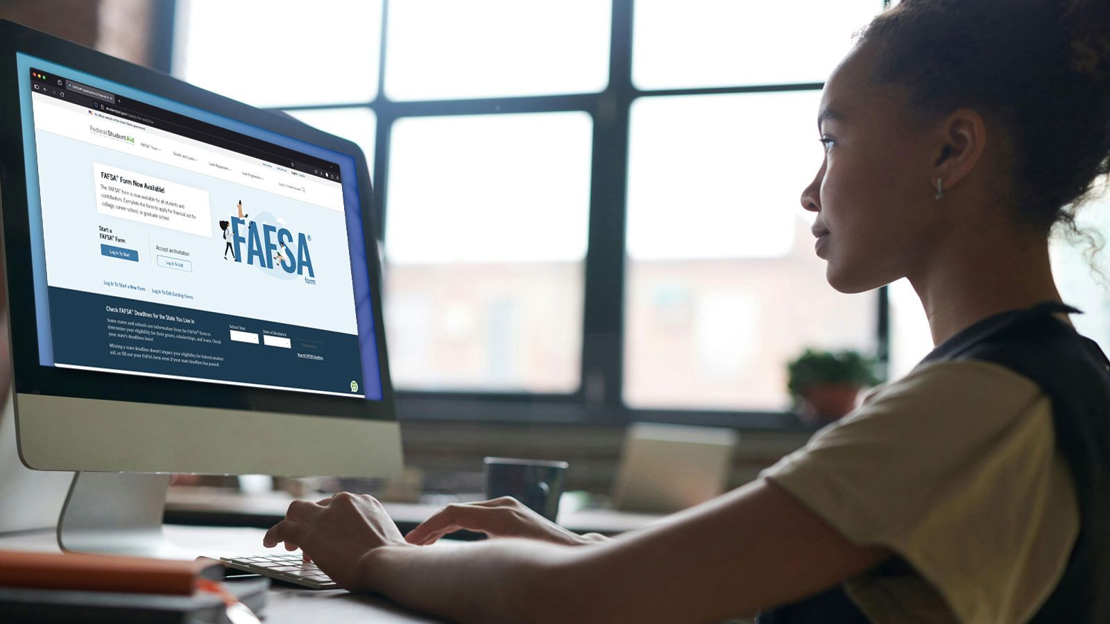 Photo - A student fills out the Free Application for Federal Student Aid on a desktop computer.