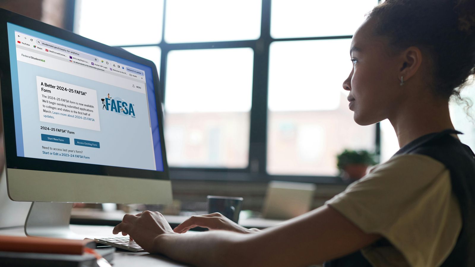 Photo - A student fills out the Free Application for Federal Student Aid on a desktop computer.