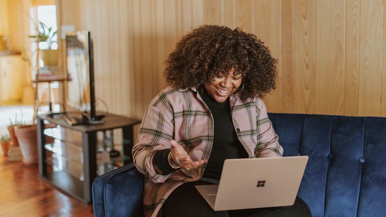 Photo - Young woman viewing her laptop and smiling