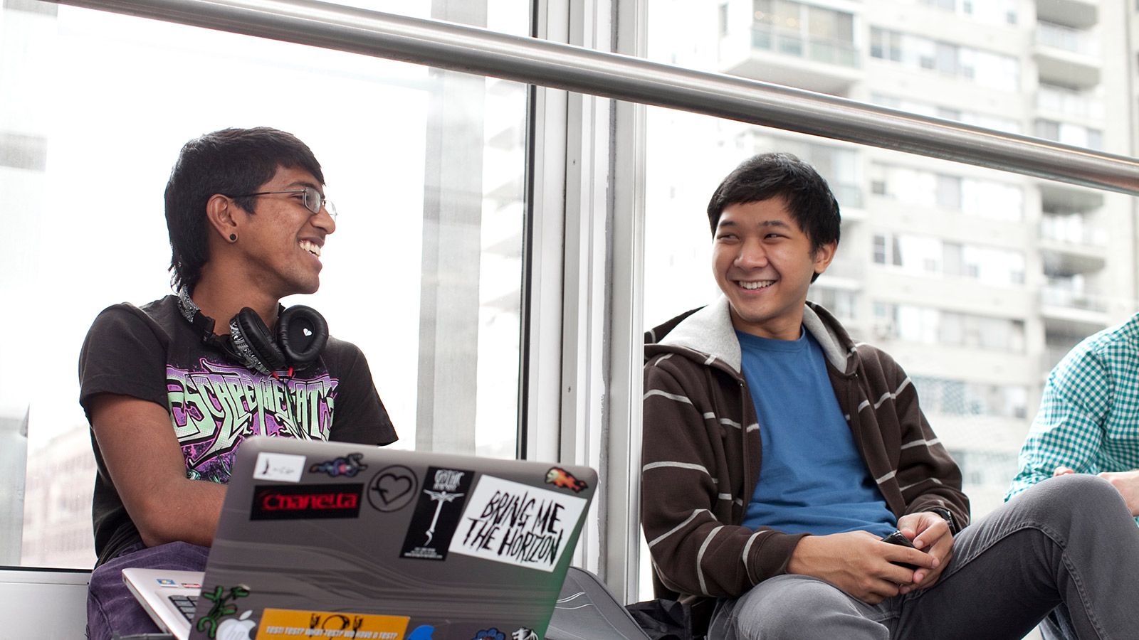 Hunter students at the library help desk ask questions of the librarian.