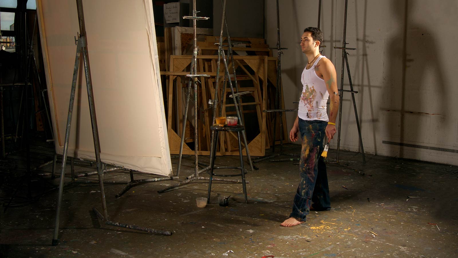 art student in art studio in front of a large canvas