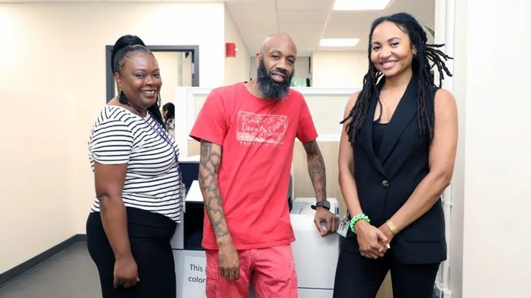 (From left) Staffers Tanisha Mathis, Kaleef Jones, and Ayanna Peeples stand in the Financial Aid Office.