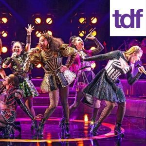 Performers sing on stage.