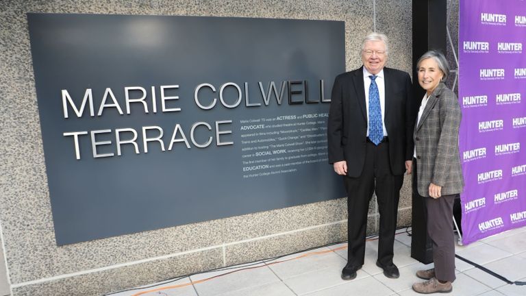 Ron Spurga and Hunter President Ann Kirschner stand next to the plaque dedicating the Marie Colwell Terrace.