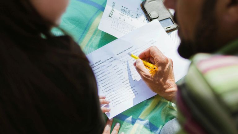 one person helping another persons study