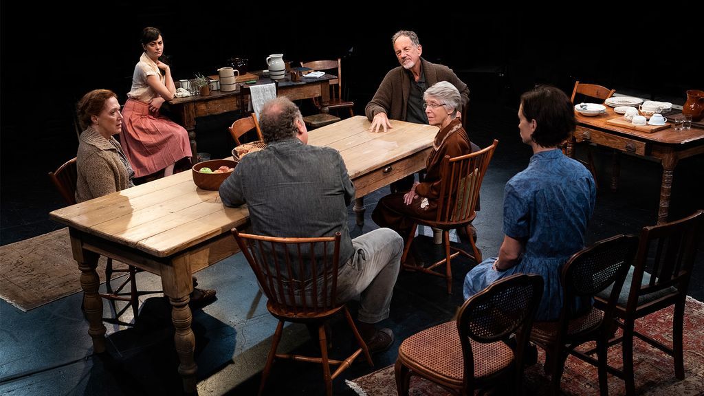 Cast of Uncle Vanya having a discussion around a table