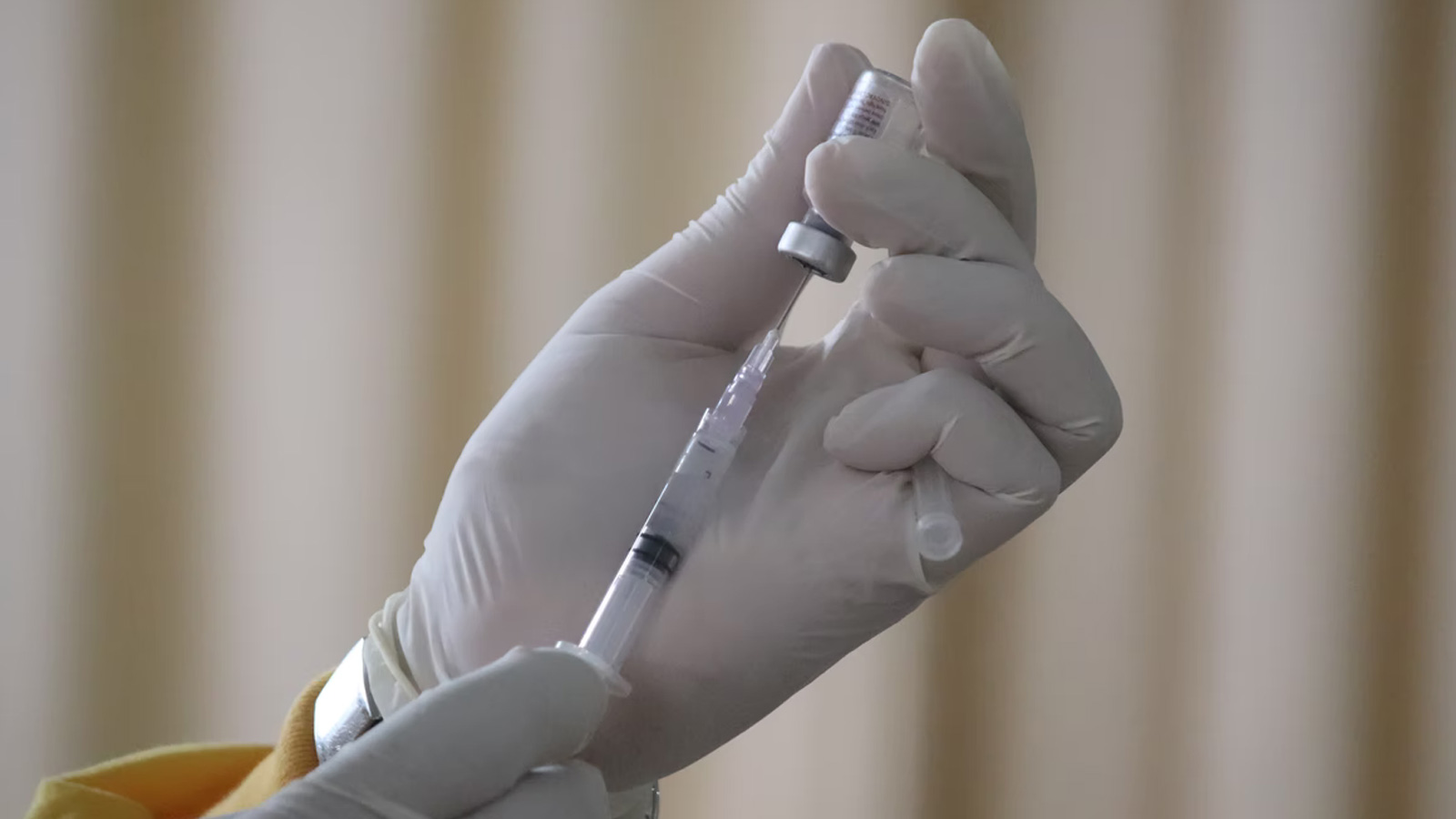 Hand with a vaccine vial