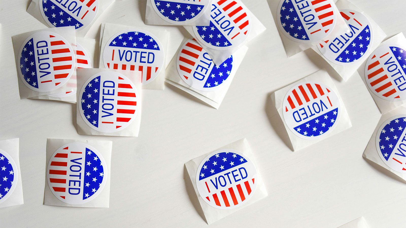 I voted stickers scattered on white table surface